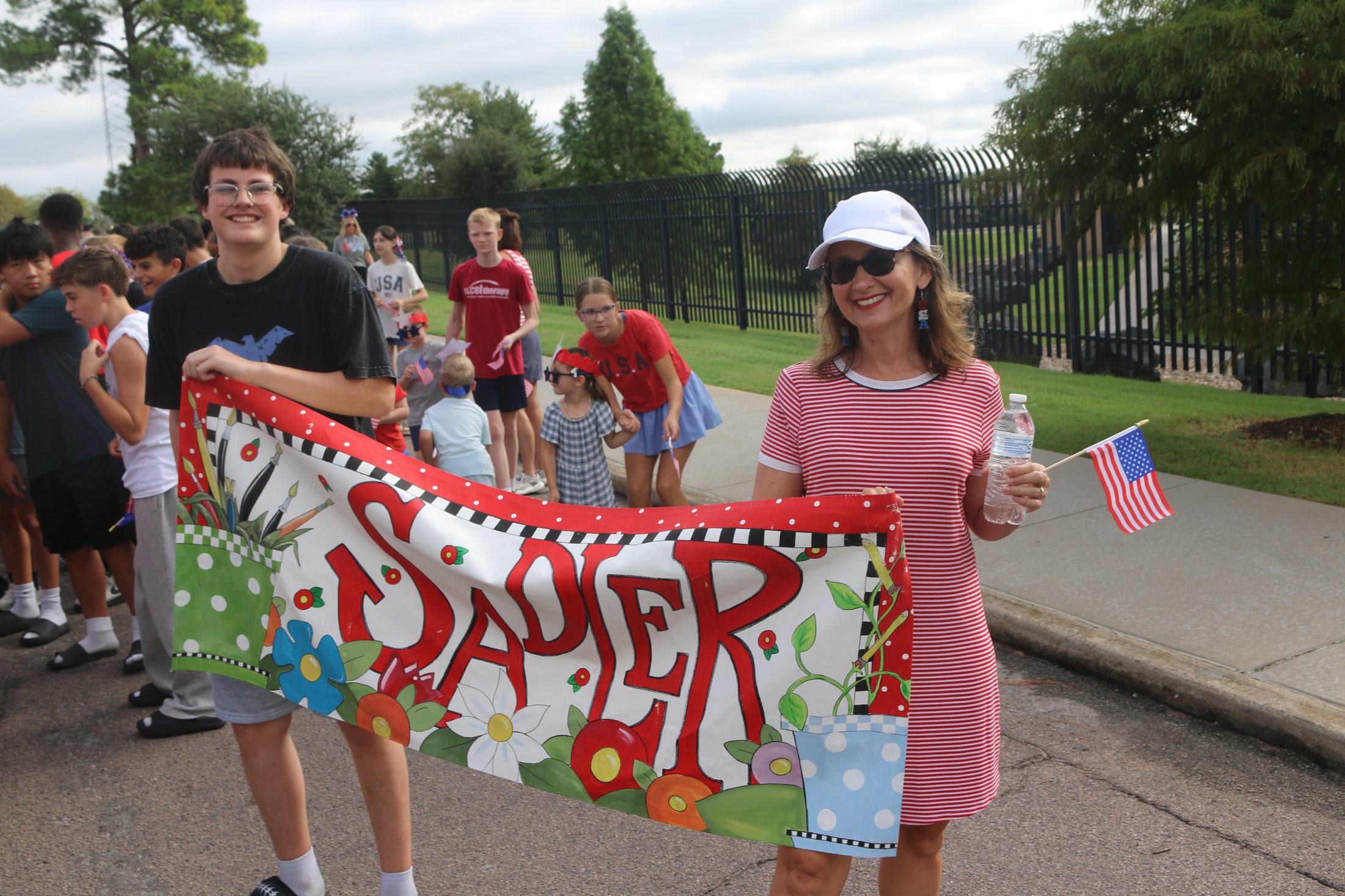 Participants carrying a Sadler Arts Academy banner in the Patriotic Parade